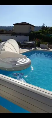 a large swimming pool with a inflatable at Grand Magnifique Studio piscine et parking privé in Manosque