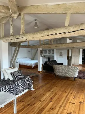 a large room with a bed and a couch at Chez Christel in Apt