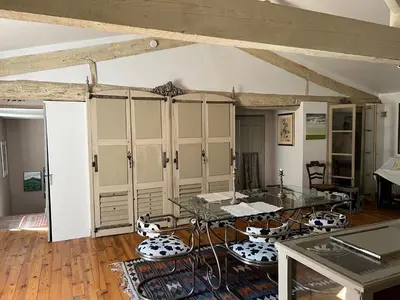 a dining room with a glass table and chairs at Chez Christel in Apt