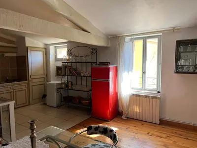 a red refrigerator in a kitchen with a window at Chez Christel in Apt