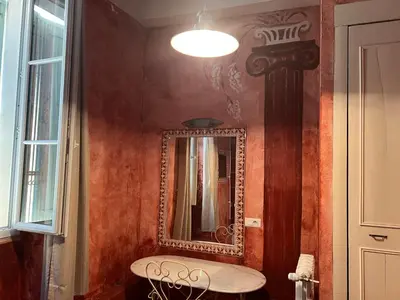 a bathroom with a mirror on the wall and a table at Chez Christel in Apt