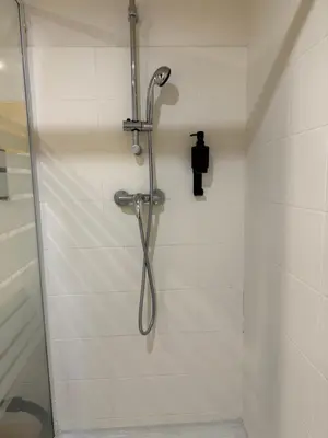 a shower with a shower head in a bathroom at Le Clos d'Aix studio 106 parking in Aix-en-Provence