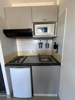 a small kitchen with a sink and a microwave at Le Clos d'Aix studio 106 parking in Aix-en-Provence