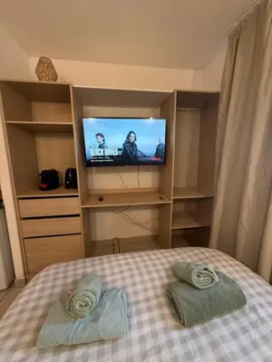 a bedroom with a bed with a television in it at Le Clos d'Aix studio 106 parking in Aix-en-Provence