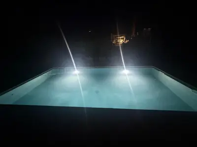 two lights on top of a swimming pool at night at Le Clos d'Aix studio 106 parking in Aix-en-Provence