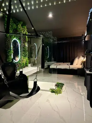 a room with a hammock and a bed with plants at BDSM TANTRA Love Room Salon-de-Provence in Salon-de-Provence