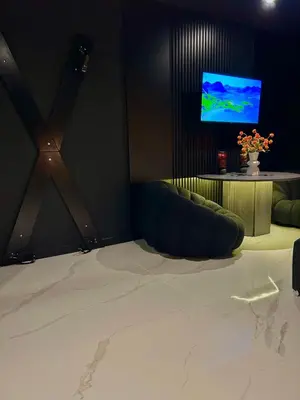 a living room with a couch and a tv at BDSM TANTRA Love Room Salon-de-Provence in Salon-de-Provence
