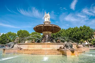 a fountain with two statues on top of it at L'Olivier - Joli duplex au cœur du centre ville à 2 pas de la Rotonde Mirabeau et des allées Provençales in Aix-en-Provence