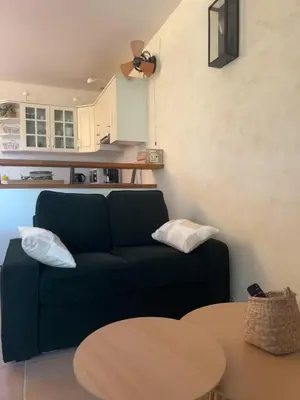 a living room with a blue couch and a table at Bastidon de Gordes in Gordes