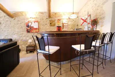 a bar in a restaurant with chairs around it at Authentique mas avec vue et piscine Eygalieres LS1-447 in Eygalières