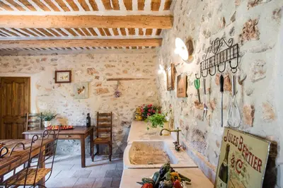 a kitchen with a sink in a stone wall at Authentique mas avec vue et piscine Eygalieres LS1-447 in Eygalières