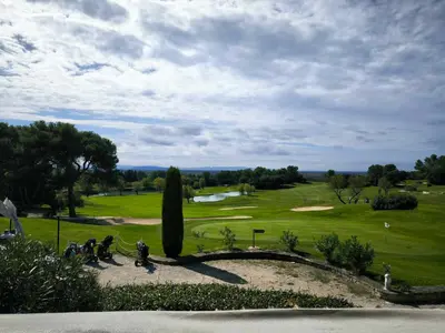 a view of a golf course with a green at Appartement T2 magnifique vue sur golf avec climatisation avec piscine in Saumane-de-Vaucluse