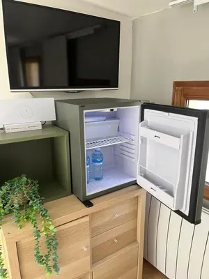 an open refrigerator with a bottle of water in it at Cocon Authentique de Roussillon in Roussillon