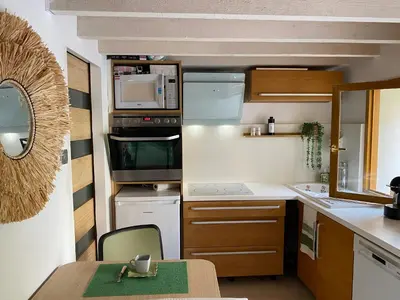 a small kitchen with a table and a kitchen sidx sidx sidx at Cocon Authentique de Roussillon in Roussillon