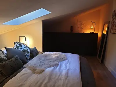 a bed with a white blanket on it in a room at Joli Appart Climatisé Hyper Calme Quartier Mairie in Aix-en-Provence