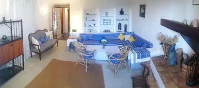 a living room with a blue couch and chairs at Mas de Regardebon in Mazan