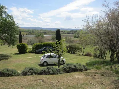 a small white car parked in a field at Mas de Regardebon in Mazan
