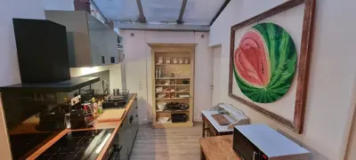 a kitchen with a picture of a watermelon on the wall at Appartement centre ville Hôtel Particulier in Carpentras