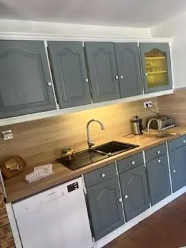 a kitchen with blue cabinets and a sink at Villa Provençale climatisée près Aix en Provence Piscine securisée alarme in Ventabren