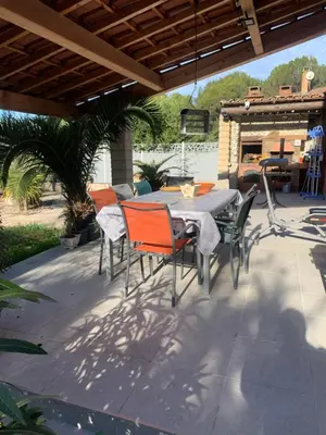 a patio with a table and chairs on a patio at Villa Provençale climatisée près Aix en Provence Piscine securisée alarme in Ventabren
