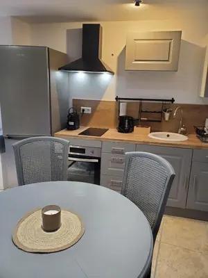 a kitchen with a table with a hat on it at La bonne adresse de Provence in Cornillon-Confoux