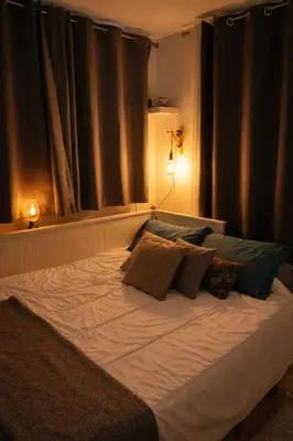 a large white bed with pillows on it in a bedroom at Le Gîte in Venelles
