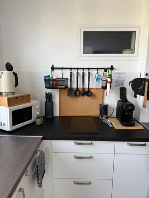 a kitchen with a table with a bowl of fruit on it at Le Gîte in Venelles