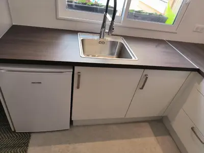 a kitchen with a counter top and a microwave at Le Gîte in Venelles