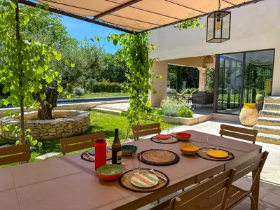 a table with food and drinks on it in a patio at La Magnanerie 1818 villa de prestige 5 étoiles Luberon in Saint-Saturnin-les-Apt