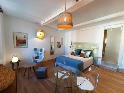 a bedroom with a bed and a glass table at Centre historique studio rénové avec vue in LʼIsle-sur-la-Sorgue