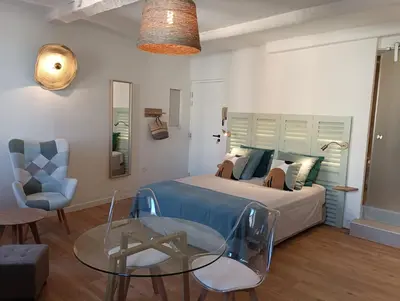 a bedroom with a bed and a glass table at Centre historique studio rénové avec vue in LʼIsle-sur-la-Sorgue