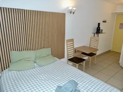 a bedroom with a bed and a table and chairs at Le Clos d'Aix studio 105 parking in Aix-en-Provence