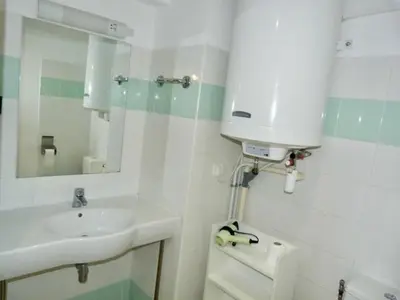 a white bathroom with a sink and a mirror at Le Clos d'Aix studio 208 parking in Aix-en-Provence