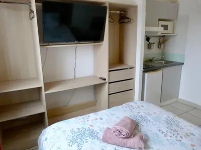 a small kitchen with a tv and a towel at Le Clos d'Aix studio 208 parking in Aix-en-Provence