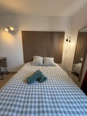 a bed with two pillows on top of it at Le Clos d'Aix studio 208 parking in Aix-en-Provence