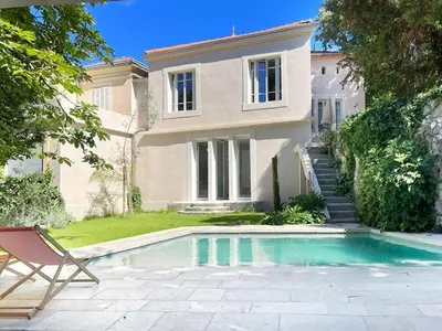a bedroom with a bed with two lights above it at Studio with garden and pool in Aix-en-Provence