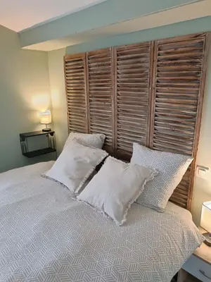 a bedroom with a large bed with white pillows at Gîte à la ferme in Sénas