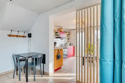 a bedroom with a bed and a table in a room at EDEN l Jardin, Bbq, Duplex l Parking Gratuit & Super Wifi l Vue Panoramique Sainte-Victoire in Aix-en-Provence