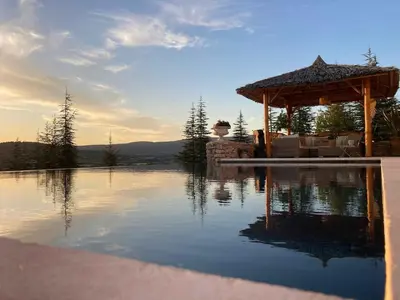 a pool of water with a gazebo on top of it at La Balinaise in Apt