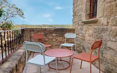 a group of chairs and tables on a balcony at Noceta in Miramas