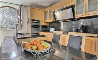 a kitchen with a bowl of fruit on a counter at Noceta in Miramas