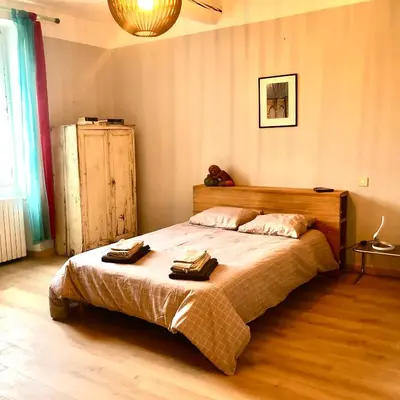 a bedroom with a bed with two towels on it at Le 140 du Ventoux in Saint-Saturnin-lès-Avignon