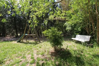 a swing and a bench in a park at La ferme du Loup in Cucuron