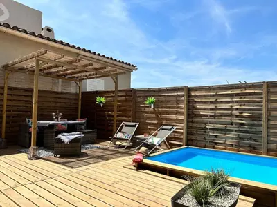 a backyard with a swimming pool and a wooden deck at La maisonnette de Tom in Caumont-sur-Durance