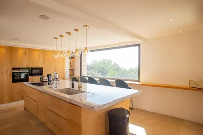 a kitchen with a large island with a counter at 8-bedroom luxury villa with pool in Gordes