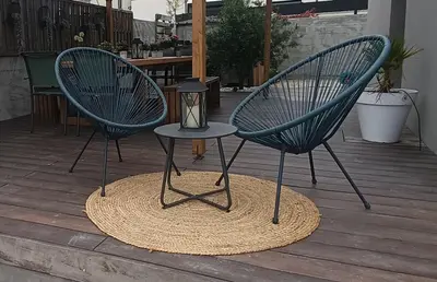 two blue chairs on a deck with a lamp on it at maison en Provence pour un été sous le soleil in LʼIsle-sur-la-Sorgue