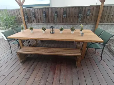 a wooden table with potted plants on a deck at maison en Provence pour un été sous le soleil in LʼIsle-sur-la-Sorgue