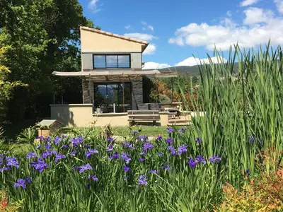 a house with a garden with purple flowers at L'ancien poulailler- The Old Hen House in Saint-Saturnin-les-Apt
