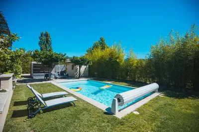 a swimming pool with a slide in a yard at L'ancien poulailler- The Old Hen House in Saint-Saturnin-les-Apt
