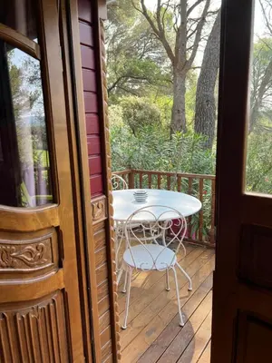 a patio with a table and chairs on a deck at Appel du Luberon in Mérindol